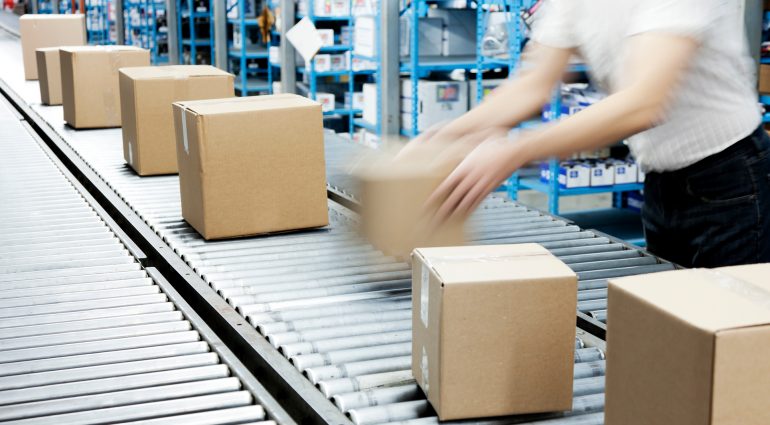 Boxes being loaded on conveyor rollers